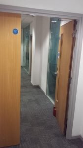 Typical fire escape route in a modern office building (note electromagnetic door stop).