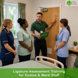 Instructor pointing to a door fixture while training ward and estates staff on ligature risk assessments.